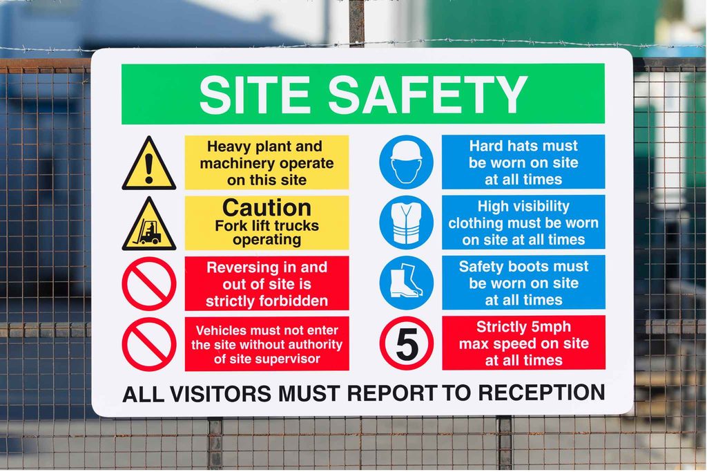 Construction site safety sign displaying PPE, machinery and visitor safety requirements for daily pre-start checks and toolbox talks.