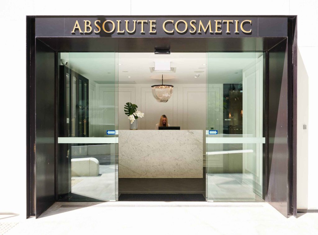 Absolute Cosmetic medical fitout project completed by Chest Construction, featuring a glass entry, reception desk and polished clinic interior.