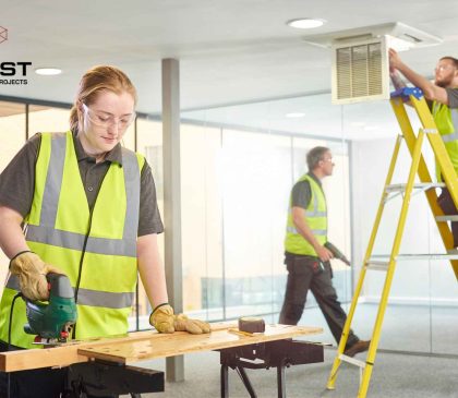 Commercial builders completing a medical fitout in Perth, with workers installing joinery and ceiling services inside a health facility space.