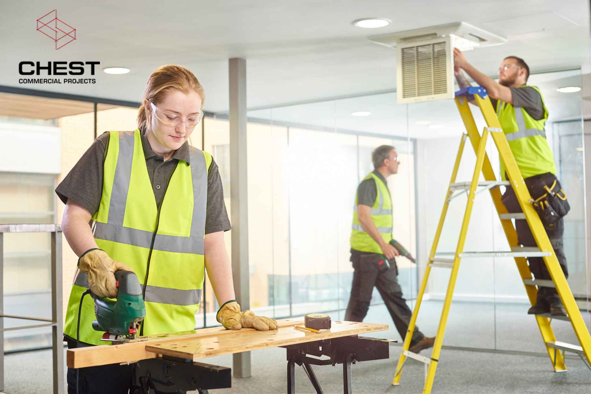 Commercial builders completing a medical fitout in Perth, with workers installing joinery and ceiling services inside a health facility space.