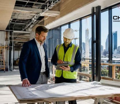 Business owner and commercial builder reviewing fitout plans inside a commercial construction site in Perth, WA